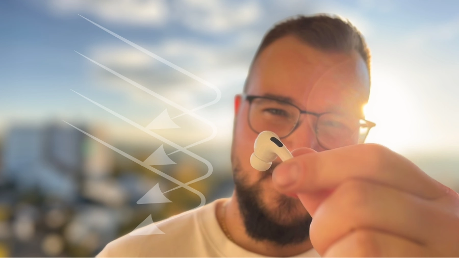 Einzelner AirPod in den Fingern haltend